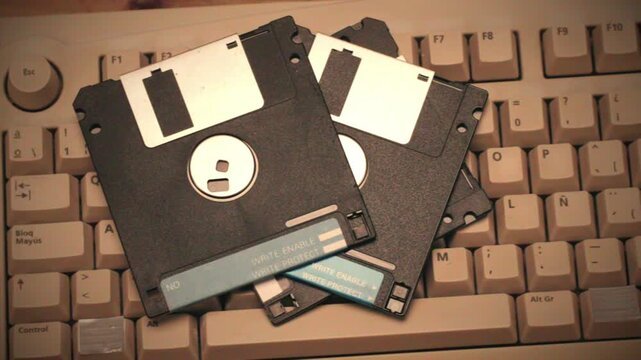 Vintage 5.25-inch floppy disks on keyboard