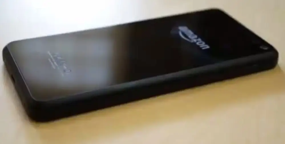 he Amazon Fire Phone, a market failure, lying flat and showing its distinctive front-facing dynamic perspective cameras.