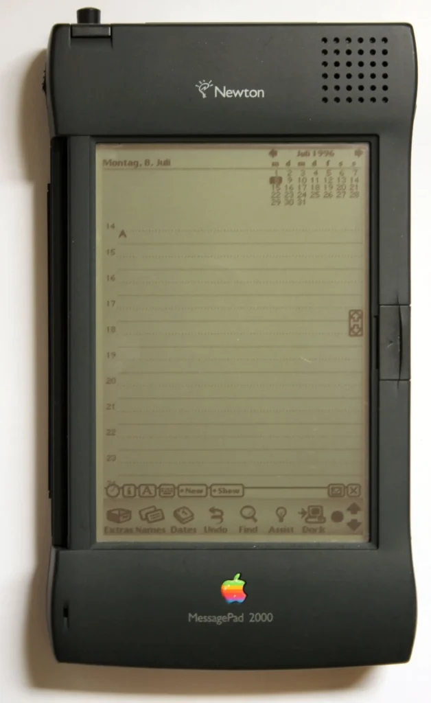 Close-up of an Apple Newton MessagePad, a pioneering but failed PDA, with its stylus resting on the monotone screen displaying a handwritten note.