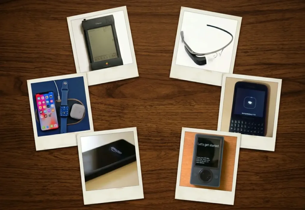 A collection of six retro-style Polaroid photographs of consumer electronics, arranged in a circle on a dark wood table. The devices include an Apple Newton MessagePad, Google Glass, Amazon Fire Phone, modern Apple iPhone and Watch on a charging mat, a Microsoft Zune, and a BlackBerry Q10. The arrangement evokes a nostalgic, museum-like gallery.
