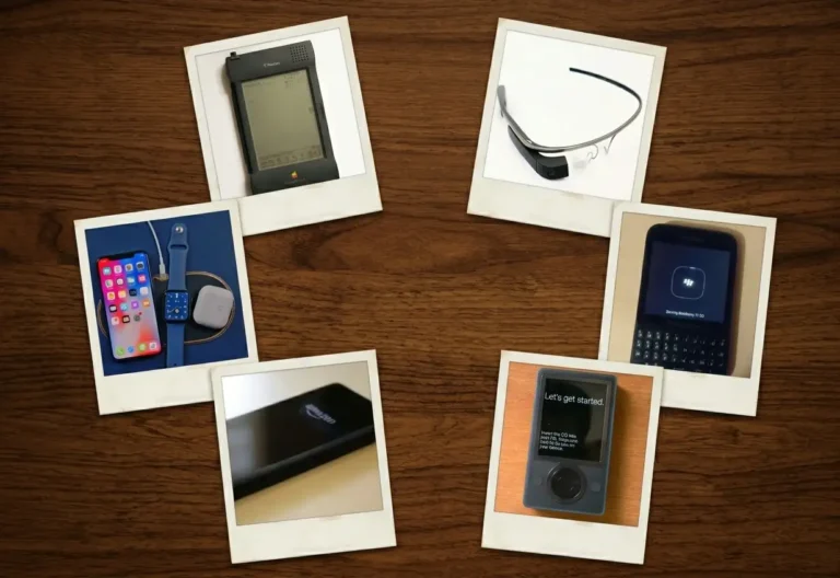 10 Tech Products That Failed Spectacularly 3 A collection of six retro-style Polaroid photographs of consumer electronics, arranged in a circle on a dark wood table. The devices include an Apple Newton MessagePad, Google Glass, Amazon Fire Phone, modern Apple iPhone and Watch on a charging mat, a Microsoft Zune, and a BlackBerry Q10. The arrangement evokes a nostalgic, museum-like gallery.