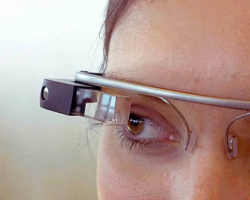 Google Glass: Too Early or Just Wrong? 1 lose-up of a person's face wearing Google Glass, highlighting the transparent prism display and front-facing camera over the right eye.
